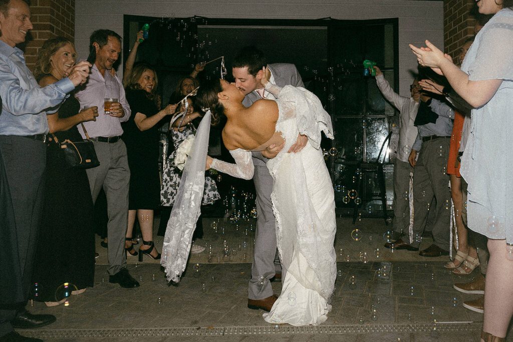 couple kiss at their bubble exit from the grove in tyler texas