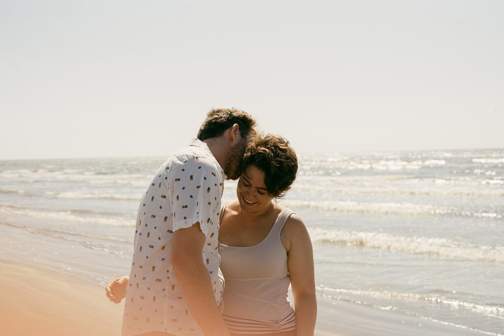 couples engagement session by the gulf in galveston tx taken by annie austin photography