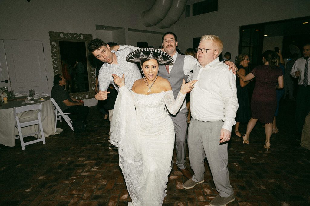 a bride at her fun reception during her wedding at the grove in tyler tx by annie austin photography