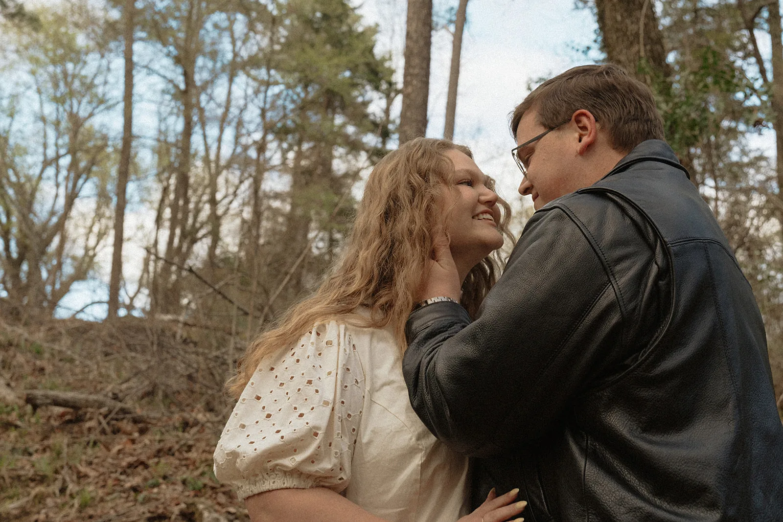 Embark on a journey through the whispering pines of Tyler, Texas with Annie Austin Photography, where each snapshot tells the story of your love. This enchanting engagement photo captures a couple's loving gaze, enveloped by the natural beauty of East Texas—perfect for couples dreaming of authentic, explorative, and heartfelt photography that embodies their unique connection.