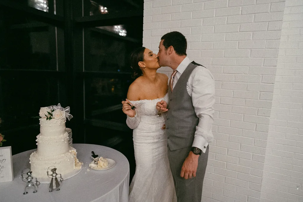 couple eat wedding cake at their wedding at the grove in tyler texas