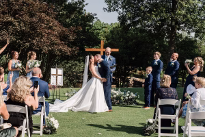 first kiss shot of bride and groom at their summer wedding in North Carolina